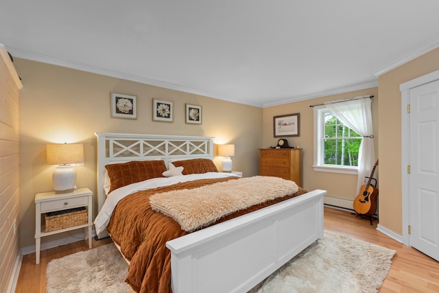 bedroom featuring light hardwood / wood-style floors and ornamental molding