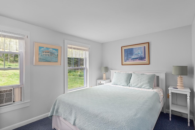 carpeted bedroom featuring multiple windows