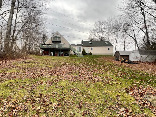 view of yard featuring a deck and a storage unit