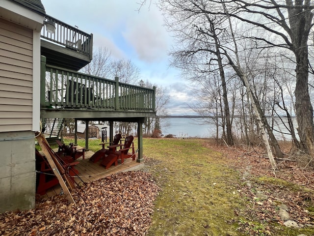 view of yard with a deck with water view