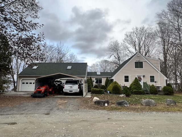 45 Douglas Dr, Newport, ME 04953 - view of front of property with dirt driveway, a carport, and a garage