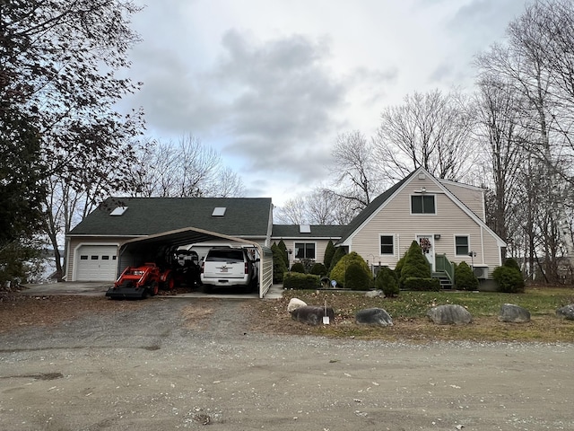 45 Douglas Dr, Newport, ME 04953 - view of front of home with dirt driveway, a garage, and a carport