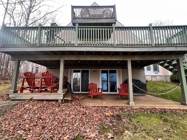 rear view of property featuring a deck