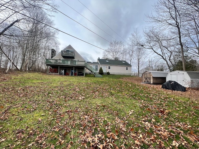 view of yard featuring a wooden deck and a shed