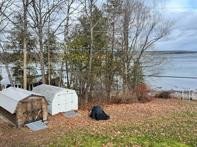 exterior space with a water view and a storage unit