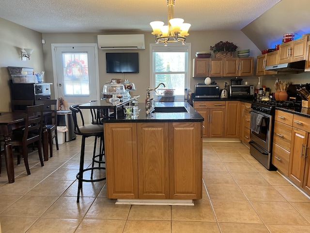 45 Douglas Dr, Newport, ME 04953 - kitchen with stainless steel appliances, a wall mounted AC, light tile patterned flooring, a textured ceiling, and lofted ceiling