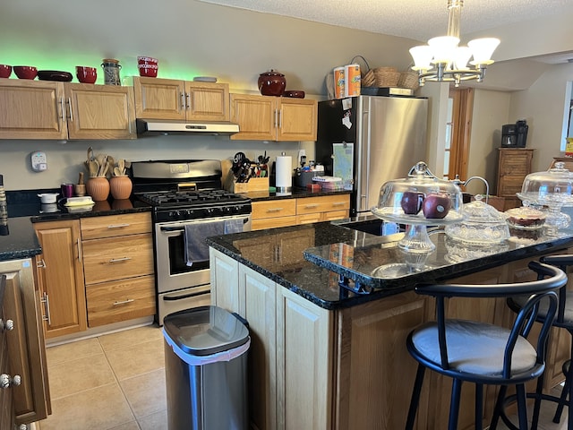 45 Douglas Dr, Newport, ME 04953 - kitchen with appliances with stainless steel finishes, under cabinet range hood, a breakfast bar, light tile patterned flooring, and a chandelier