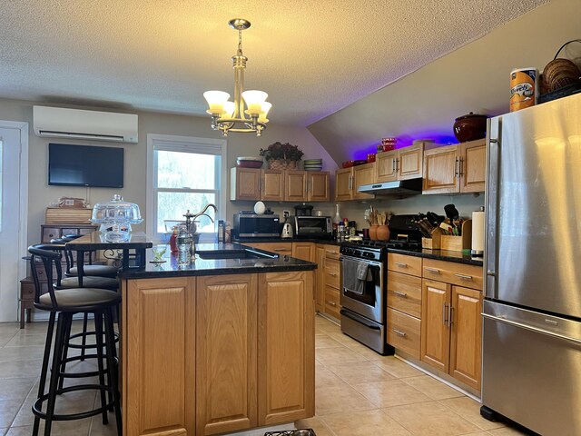 45 Douglas Dr, Newport, ME 04953 - kitchen featuring appliances with stainless steel finishes, an AC wall unit, under cabinet range hood, dark countertops, and a chandelier