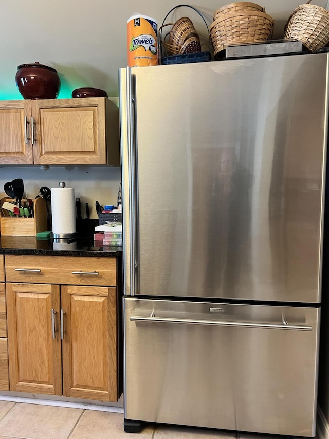 45 Douglas Dr, Newport, ME 04953 - kitchen with freestanding refrigerator, light tile patterned floors, and dark stone countertops