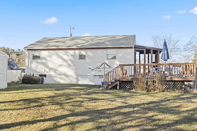 back of house with a lawn, a sunroom, and a deck