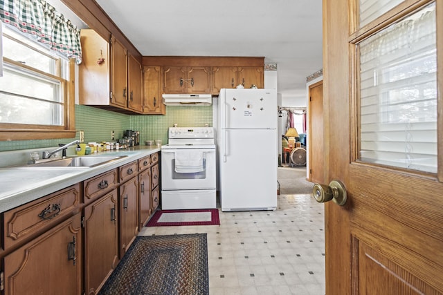 kitchen with sink and white appliances