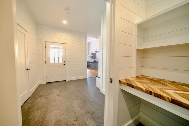 entrance foyer featuring wood walls