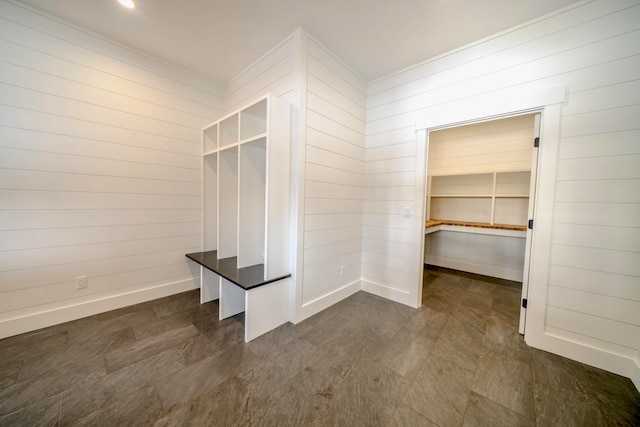 mudroom featuring wooden walls