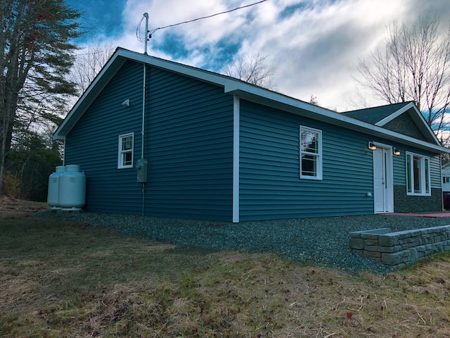 view of side of home with a yard