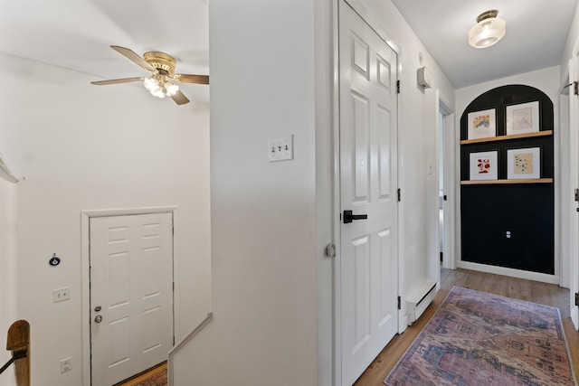 foyer featuring ceiling fan and wood-type flooring