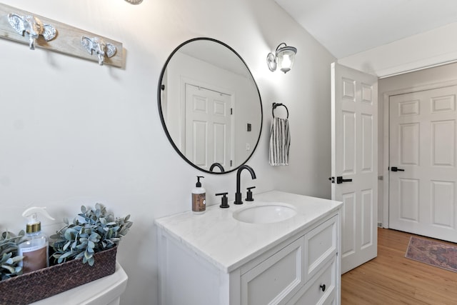 bathroom featuring hardwood / wood-style flooring, vanity, and toilet