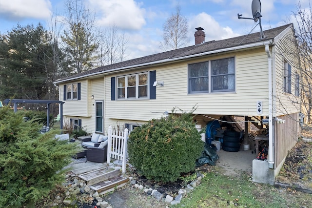 rear view of house with an outdoor living space