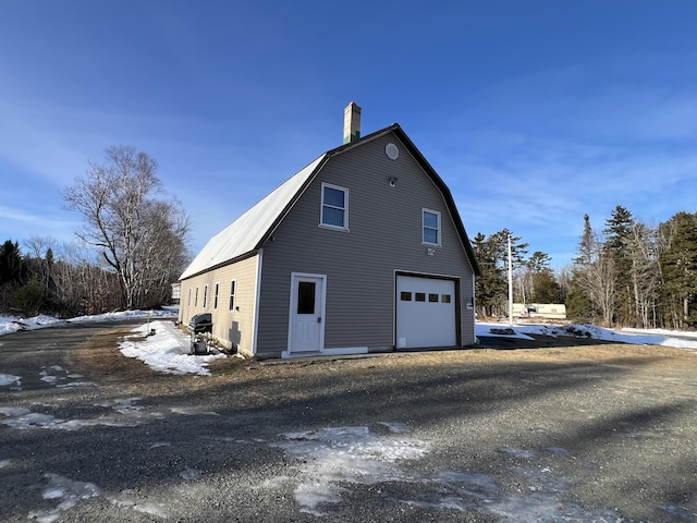 snow covered property featuring a garage