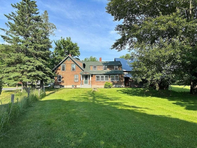 back of house with a lawn