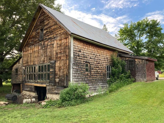 view of side of property with a yard