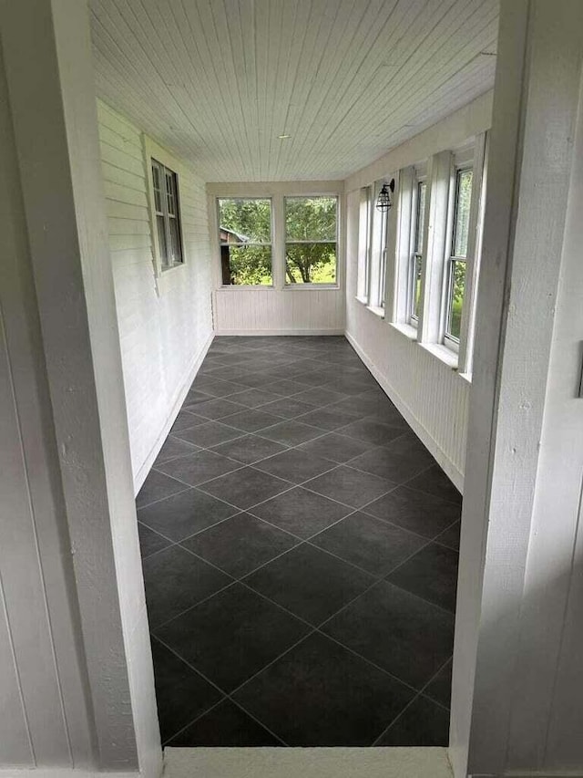 unfurnished sunroom with wood ceiling