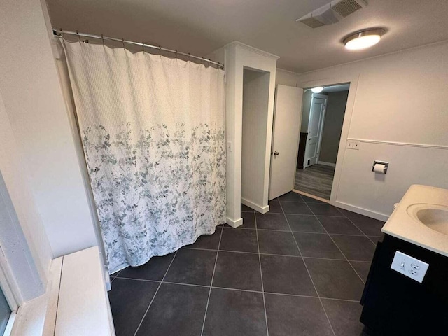 bathroom with tile patterned flooring and vanity