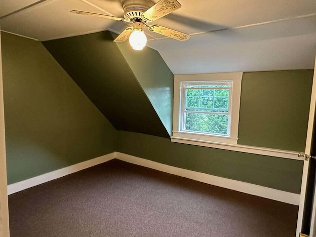 additional living space featuring carpet floors, vaulted ceiling, and ceiling fan