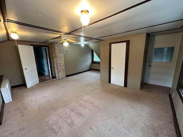 interior space featuring light carpet, a textured ceiling, and ceiling fan