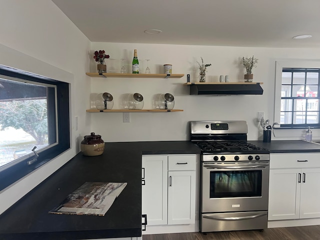 kitchen featuring white cabinets, gas range, ventilation hood, and dark wood-type flooring