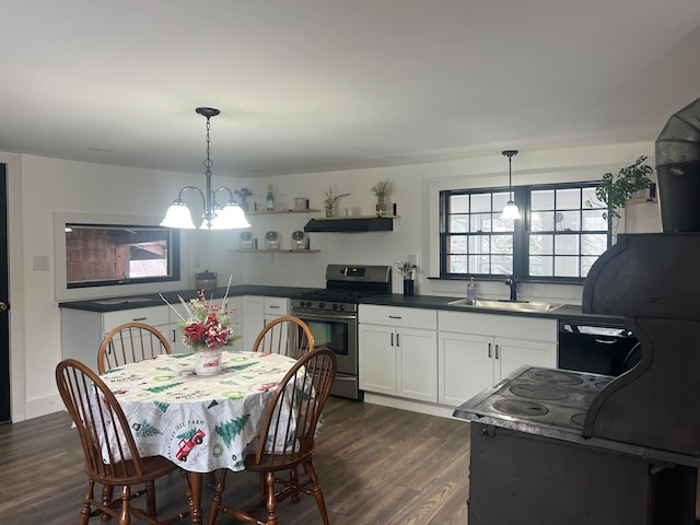 kitchen featuring sink, dark hardwood / wood-style floors, decorative light fixtures, white cabinetry, and stainless steel range with gas stovetop