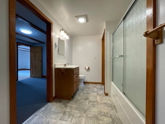 full bathroom featuring vanity, combined bath / shower with glass door, and toilet