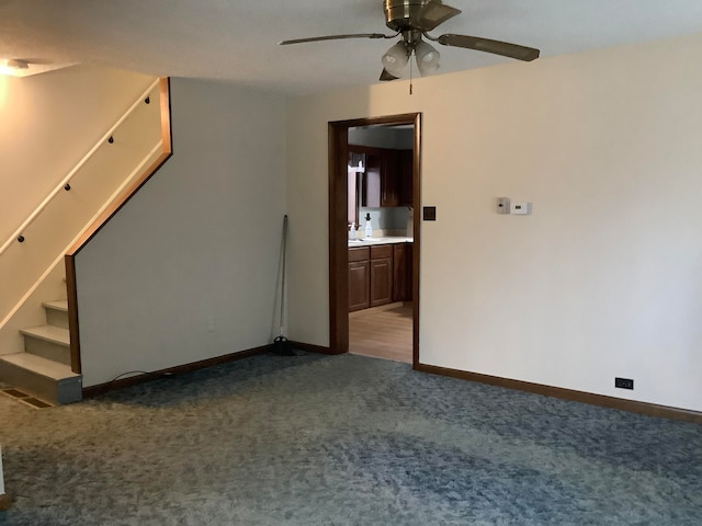 spare room featuring light carpet and ceiling fan