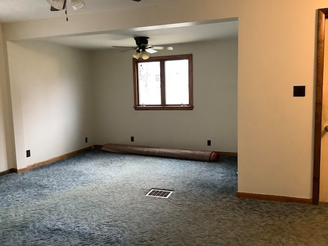 carpeted spare room featuring ceiling fan