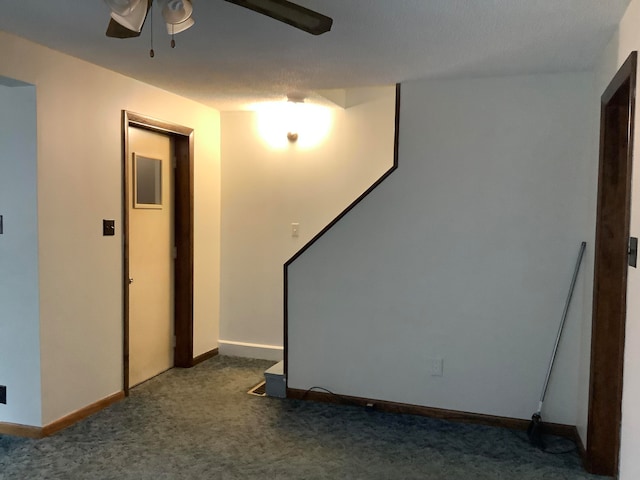 carpeted spare room with ceiling fan