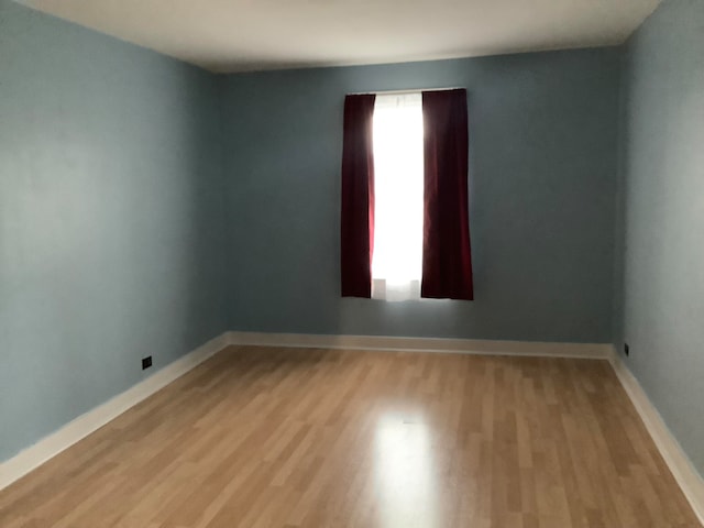 empty room with light hardwood / wood-style flooring