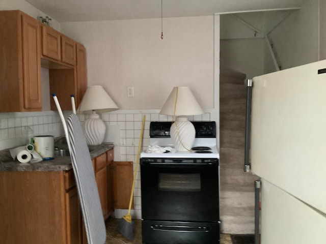 kitchen with white appliances and backsplash