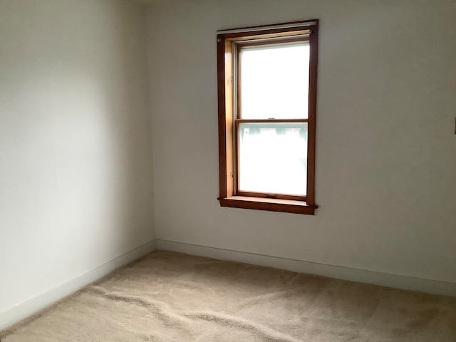 unfurnished room with light colored carpet