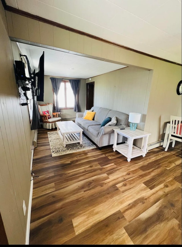 living room with dark wood-type flooring and wood walls