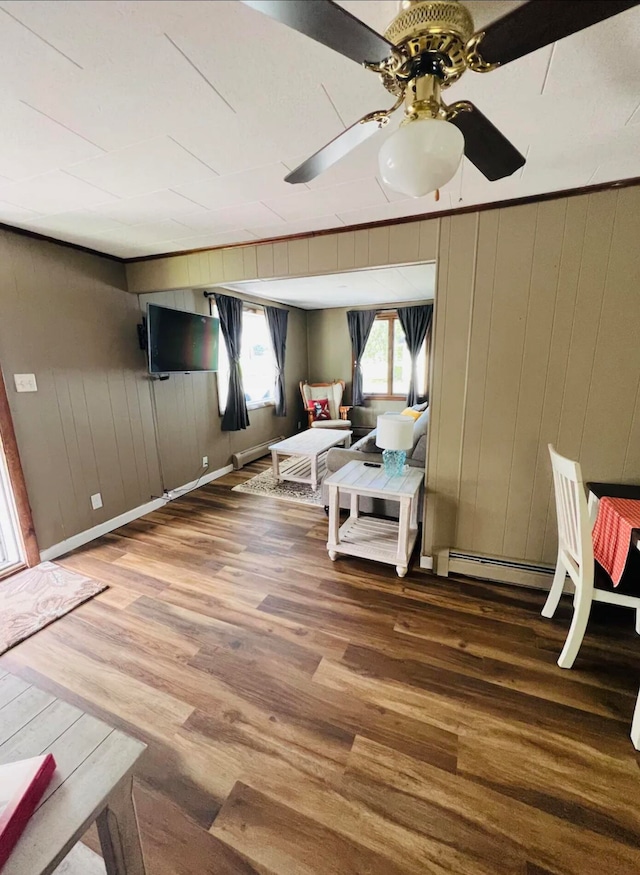 interior space featuring hardwood / wood-style flooring, ornamental molding, and ceiling fan