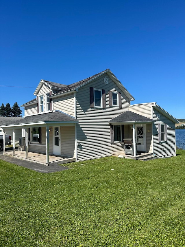 back of property with a yard and a patio