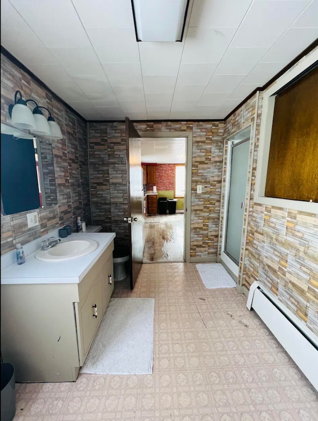 bathroom featuring vanity, a baseboard radiator, and walk in shower