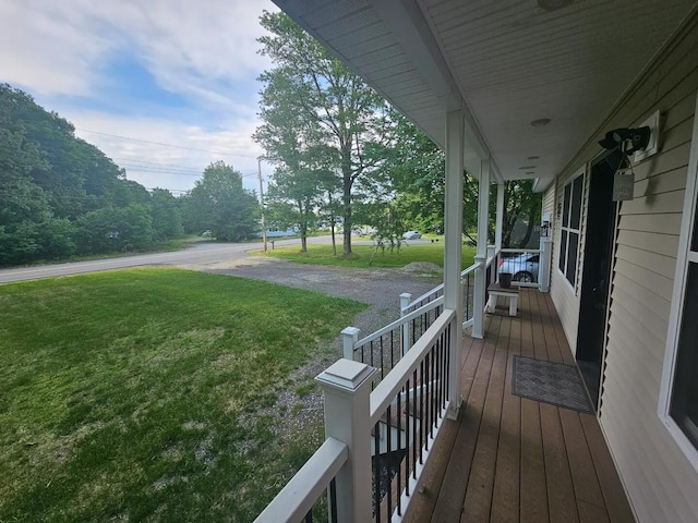 deck featuring a lawn and a porch