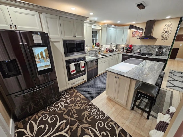 kitchen with backsplash, wall chimney exhaust hood, sink, black appliances, and decorative light fixtures