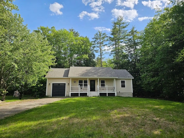 view of front of house with a front yard, a porch, and a garage