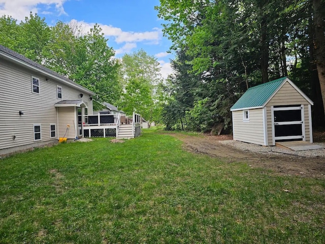 view of yard with a storage shed and a wooden deck