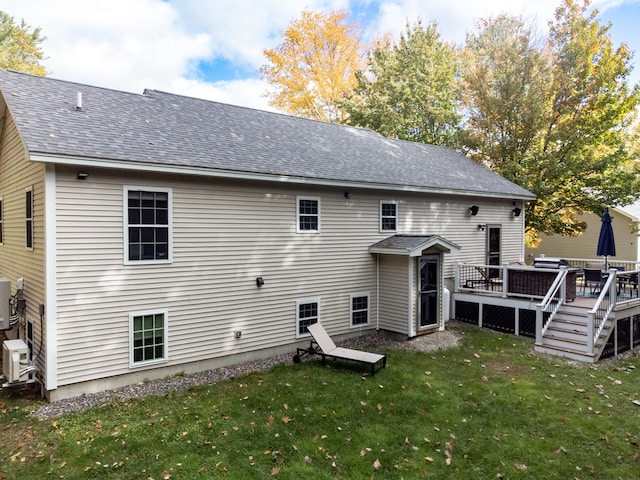 rear view of house featuring a yard and a wooden deck