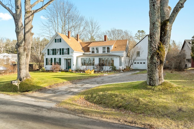 view of front of home featuring a garage and a front lawn