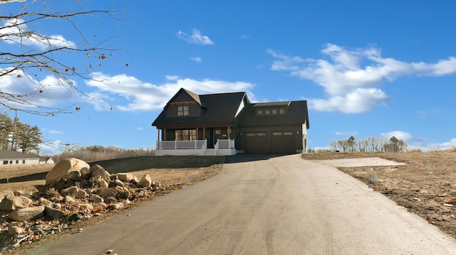 view of front of house with a porch and a garage