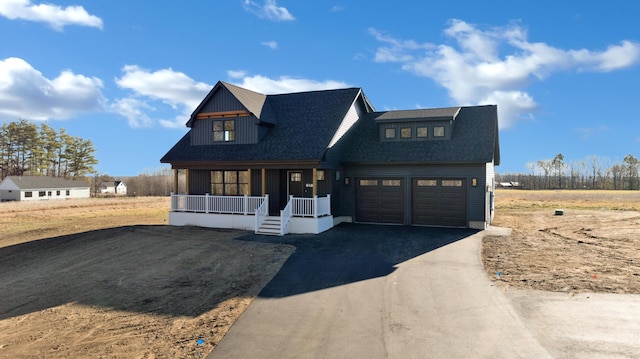 modern inspired farmhouse featuring a garage and covered porch