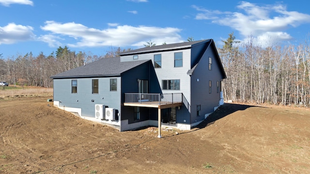 rear view of house featuring ac unit and a wooden deck